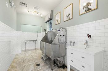 A bathroom with a stainless steel tub in the middle of it